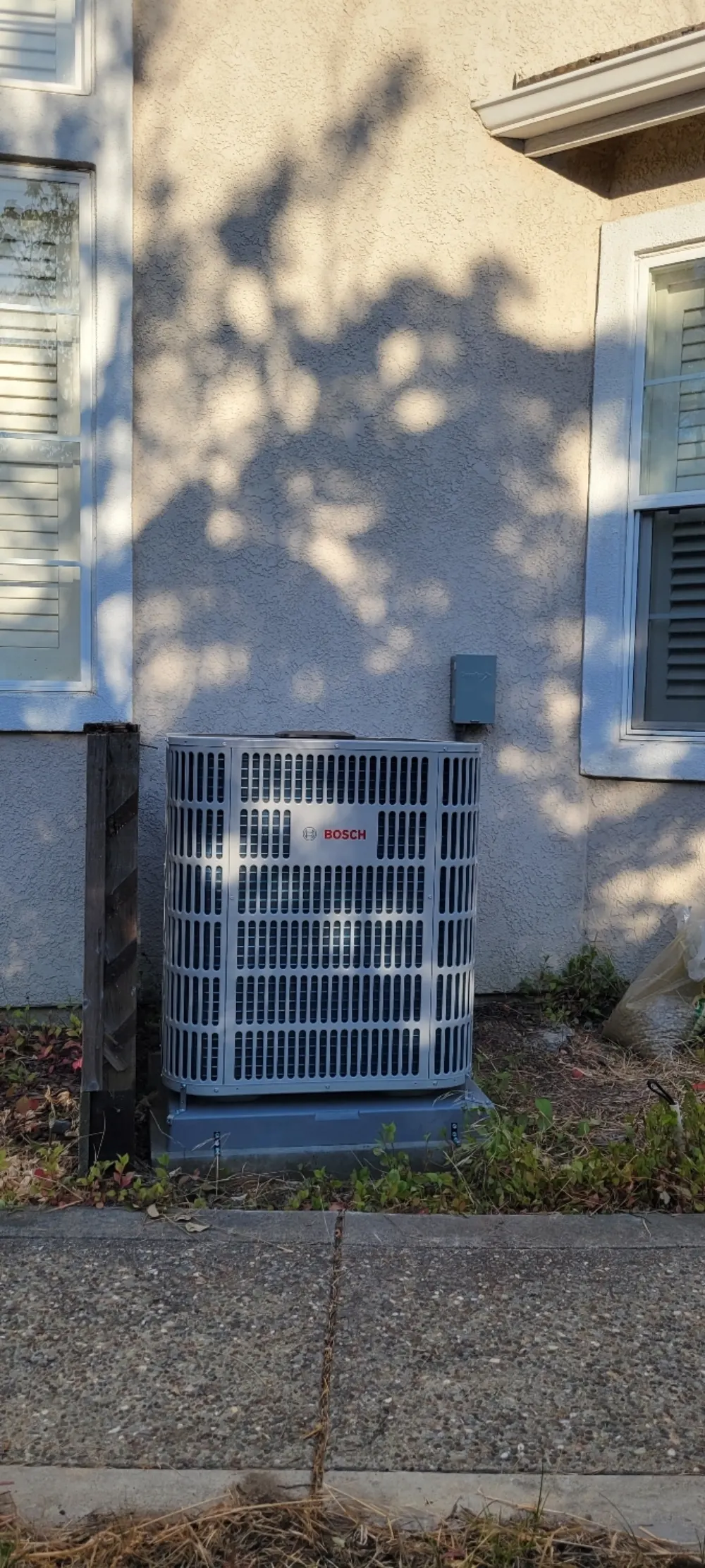 Bosch heat pump outdoor unit installed alongside a Bay Area home