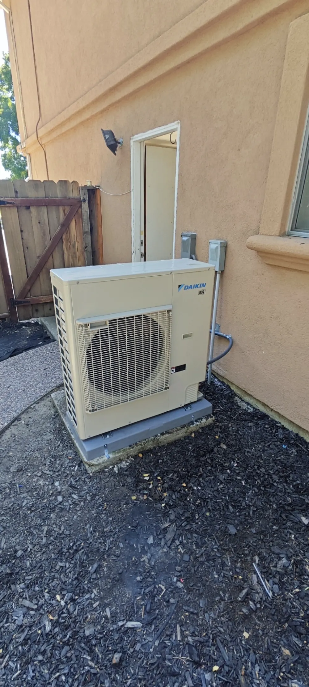 Daikin heat pump outdoor unit installed in a side yard in Livermore