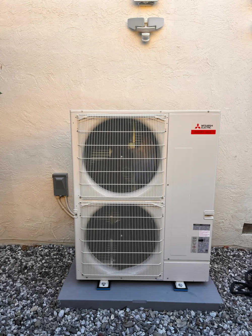Mitsubishi Electric SMART MULTI heat pump condenser installed on a concrete pad in San Jose