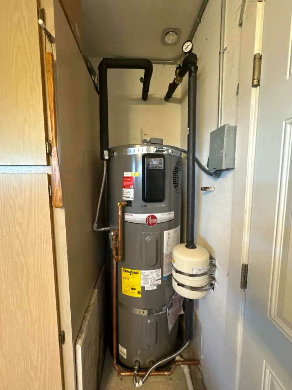 Rheem ProTerra hybrid heat pump water heater installed in a utility closet