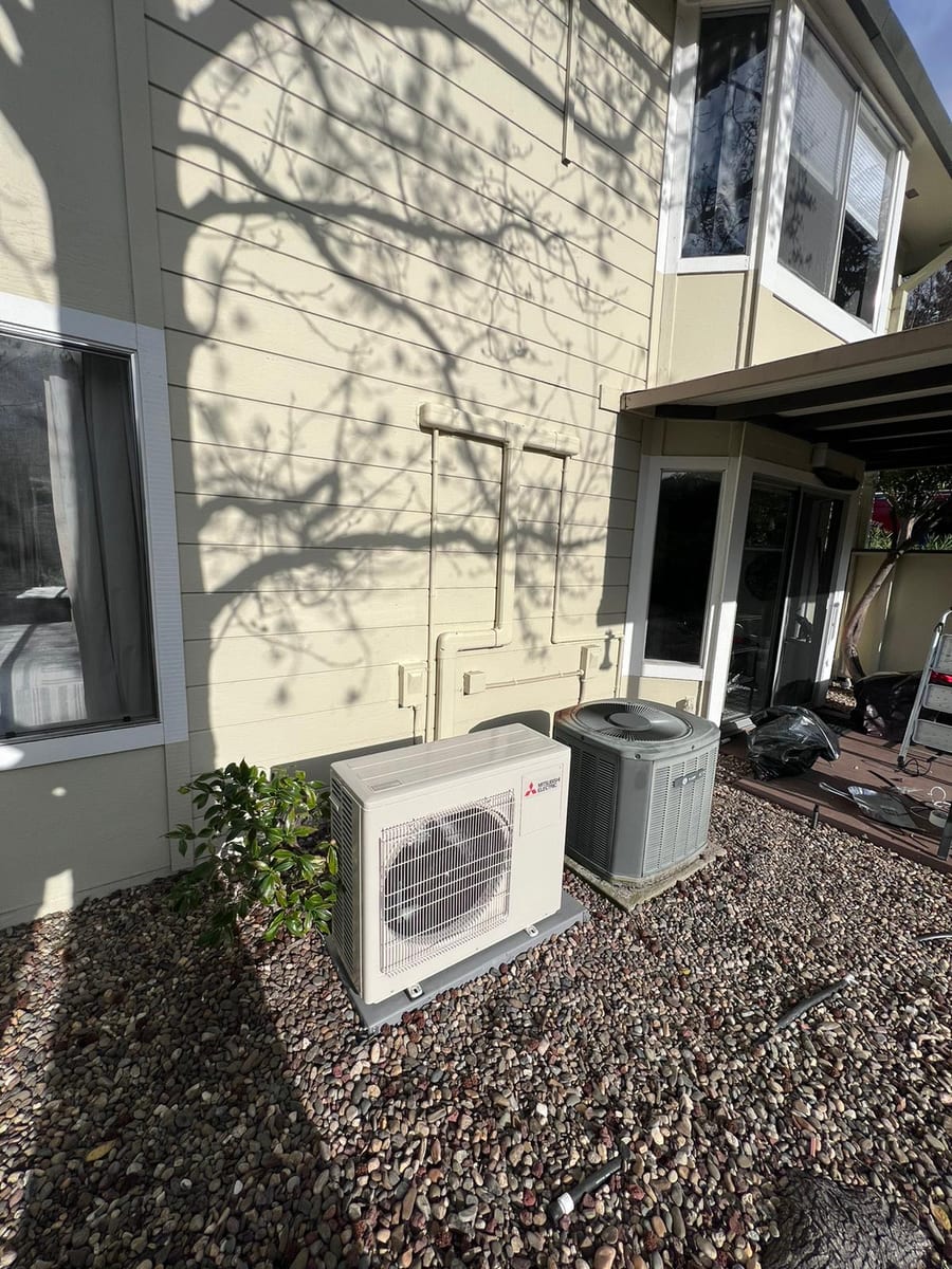 Mitsubishi ductless heat pump outdoor unit installed by Galaxy Heating & Air at an Easton Addition Burlingame home