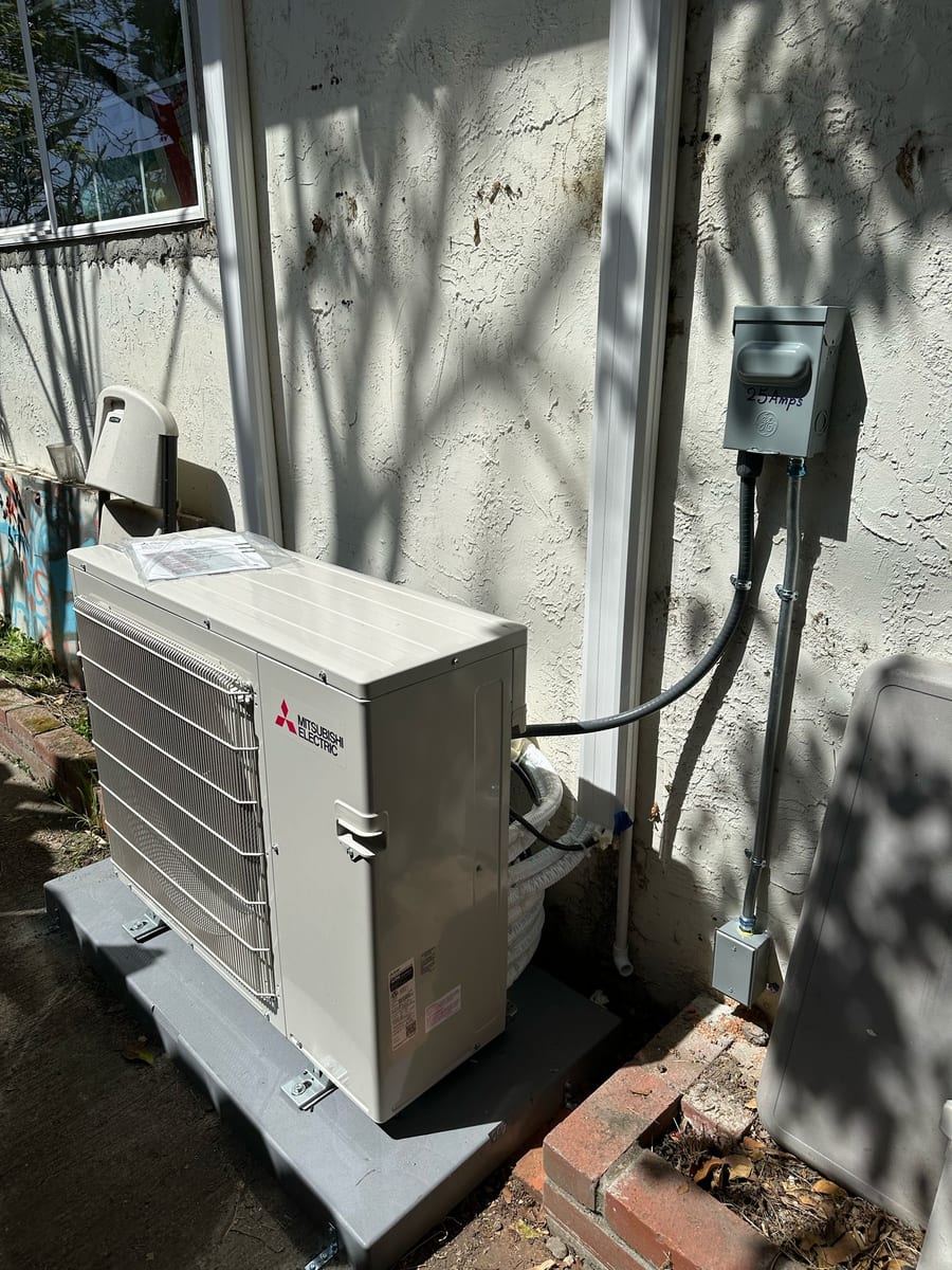 Mitsubishi ductless heat pump outdoor unit installed by Galaxy Heating & Air at a Mission Hills Daly City home