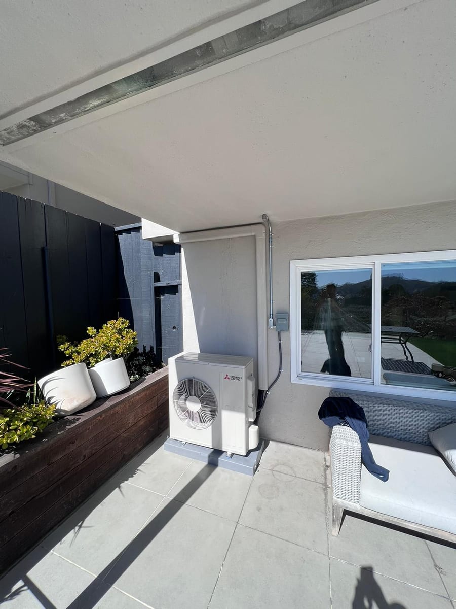 Mitsubishi ductless heat pump outdoor unit installed by Galaxy Heating & Air on a hillside patio at a Campolindo Moraga home