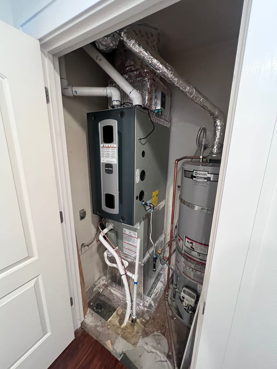 New gas furnace and A.O. Smith ProLine water heater installed by Galaxy Heating & Air in a utility closet at a Newark home