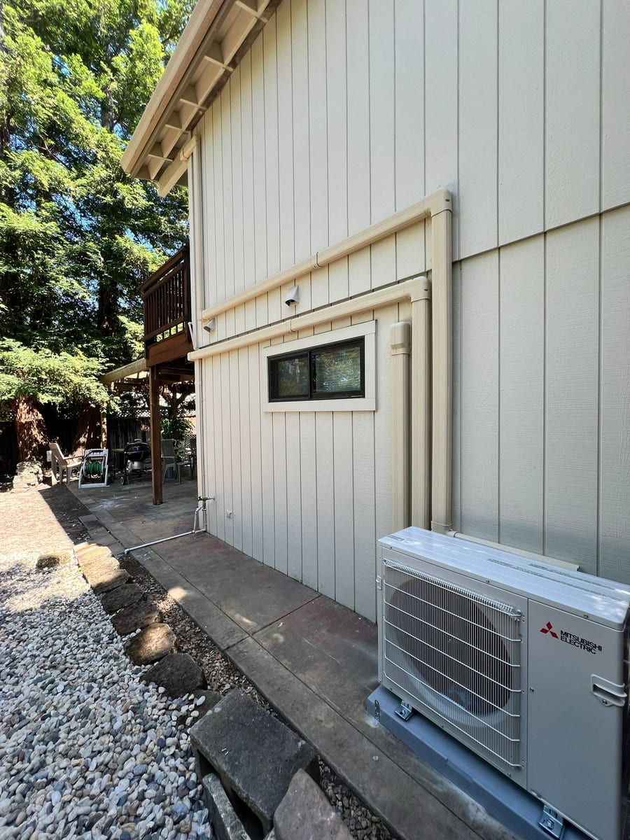 Mitsubishi Electric ductless heat pump outdoor unit installed by Galaxy Heating & Air at a Sleepy Hollow Orinda home nestled among redwoods